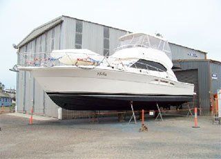 Large white yacht outside a warehouse